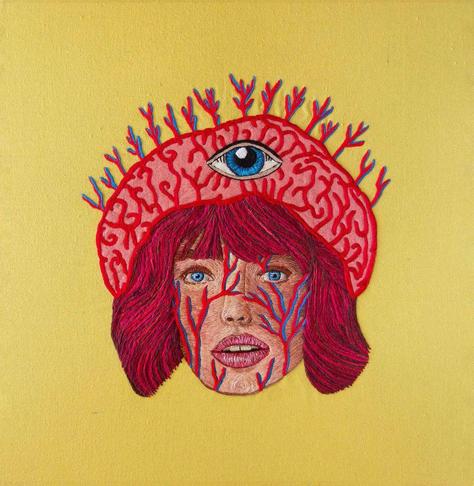 A textile artwork depicting a woman with large veins on her face, wearing a brain-shaped beanie with an eye in the center, set against a bright yellow background.