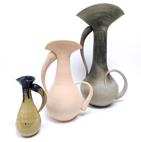 Triptych of pitchers. Inspired by water drops. 3 pitchers of different sizes and at different ceramic stages. From left to right. Small pitcher, glazed fired, one handle, one sided spout. Medium pitcher, bisque fired, double handle, double spout. Large pitcher, greenware stage, double handle with one wrapping around, double spout.
