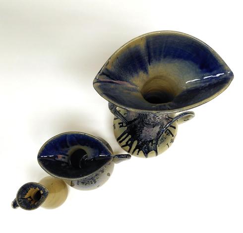 Triptych of ceramic pitchers. Inspired by water drops. 3 pitchers of different sizes. View from the top. Eye shape like spout.