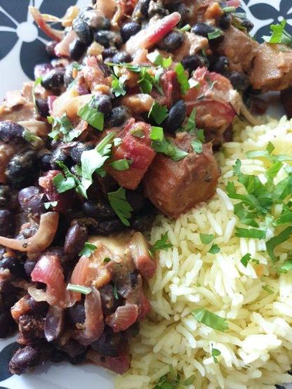 A plate of Black bean & Roasted Root Vegetables (carrot, sweet potato, parsnip, beetroot) (don't forget the onions, celery, and fresh spices) Curry, served with Basmati rice and topped with fresh coriander.