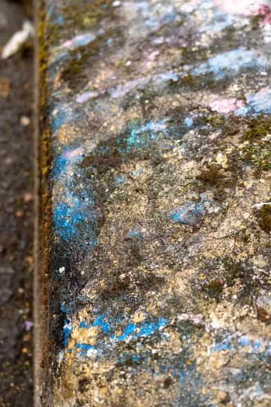 random colours of spray paint on rough concrete