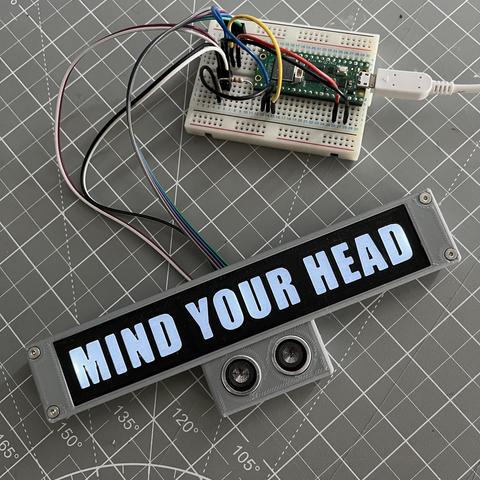 Raspberry Pi Pico with illuminated 'Mind Your Head' sign