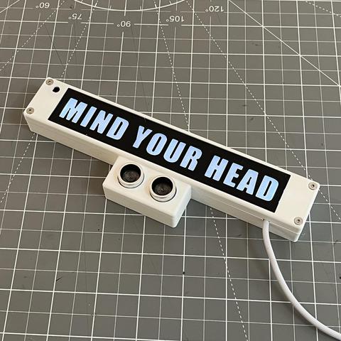 Illuminated 'Mind Your Head' sign