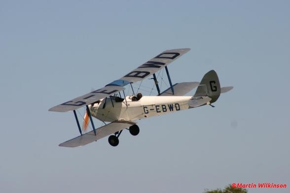 DH60X Hermes Moth flies through a clear blue sky during a Shuttleworth event at Old Warden.