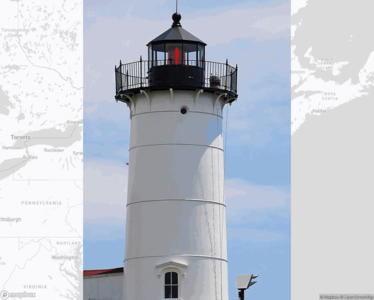A photo of a lighthouse from the linked website, overlaid on a cropped world map where it's located.