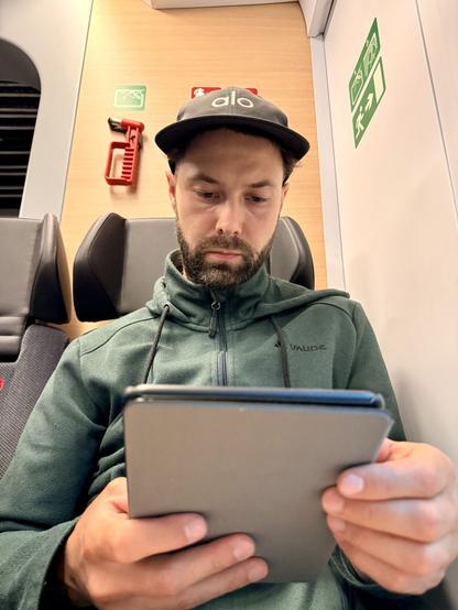 Picture of Julian tiredly reading on his eReader
