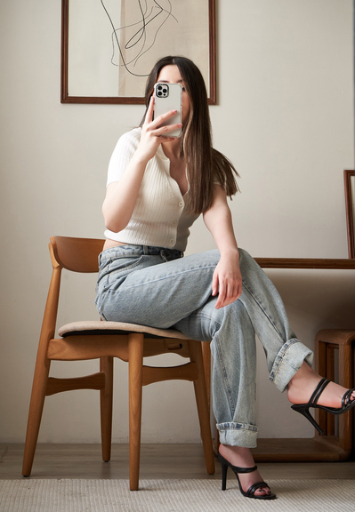 Gabriela Inzunza for Avice, sitting down taking a selfie on a mirror