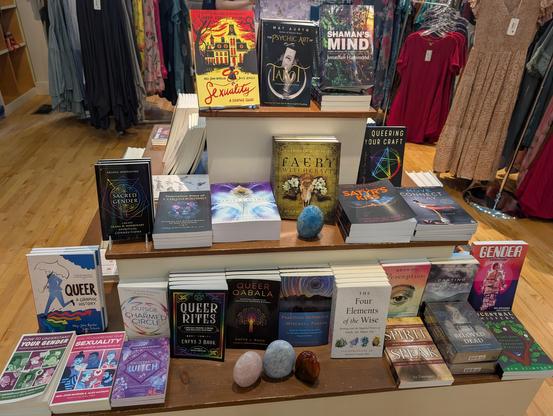 Book display featuring a number of queer and queer magick-related titles