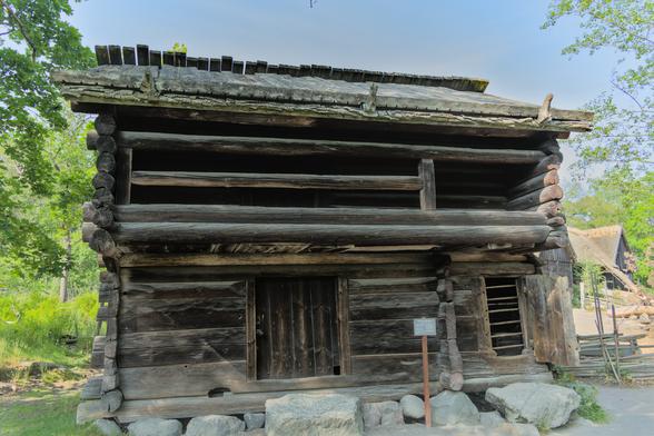A photo of an old log cabin/house. This was apparently the first two story building moved to Skansen a long time ago.
The ground floor was for living in, and had a privy (which can ironically be seen now through an open window). The first floor would be used to sleep in in summer, and store grains after the harvest.