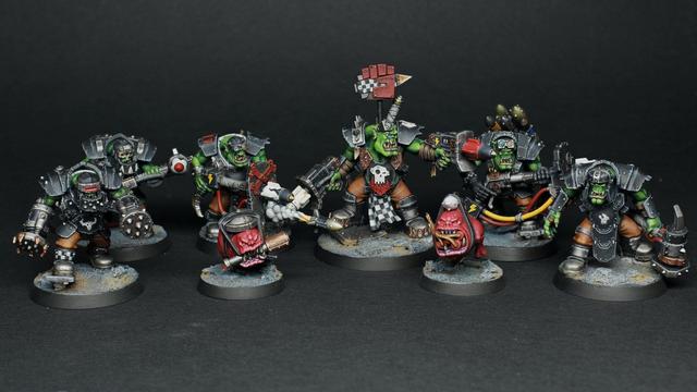 Games Workshop's Kill Team warband "Wrecka Krew". Hand painted. It is a sci-fi themed group of 8 miniatures. 6 of them are orks, wearing a black armour. Some of them have pistols and rocket launchers, some others meelee weapons. Additionally there are 2 red squigs porting bombs and granades with their mouth.
