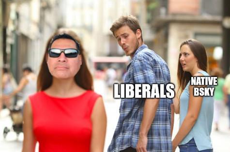 Meme with Lakotaman face over 1st woman, boyfriend labeled 'Liberals' looking back at her, and girlfriend labeled ''Native Bsky' looking at him offended...