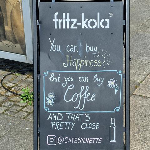 Sidewalk sigh from Cafe Sylvette "you can't buy happiness, but you can buy coffee, and that's pretty close"