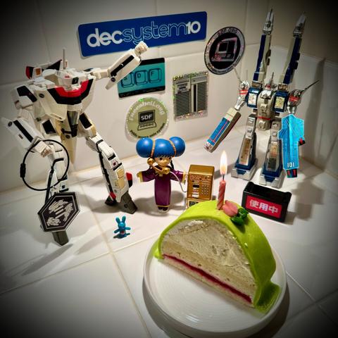 A birthday cake slice with SDF anime figures and SDF stickers