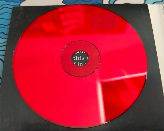 Reverse side of one of the CDs, tinted red.