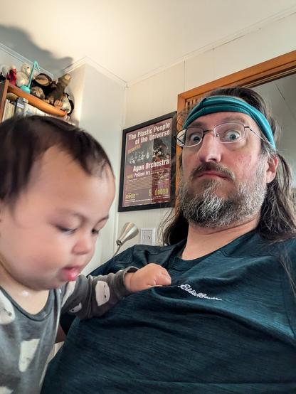 Baby with fistful of shirt in quasi-intimidating fashion (but actually just for balancing)