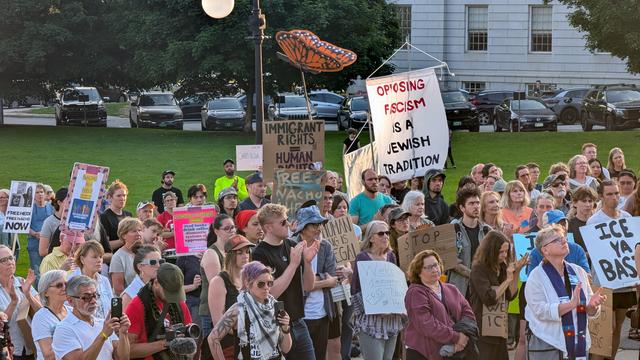 Crowd holding signs "opposing fascism is a Jewish tradition", "immigrant rights are human rights", and a cardboard monarch butterfly