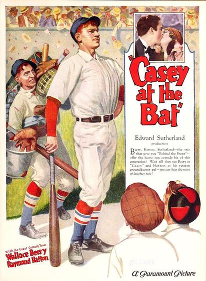 An ad for the film. There are two baseball players. A taller player is in front of another shorter player. Both player are dressed in white clothes and wearing black shoes. We can see two boys looking at them. In a smaller photo there is a couple kissing.