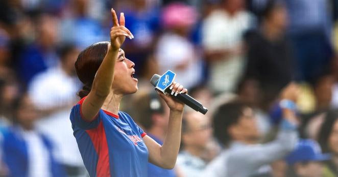 Nezza sings the national anthem before the game between the Los Angeles Dodgers and the San Francisco Giants in Los Angeles on Saturday. Jessie Alcheh / AP