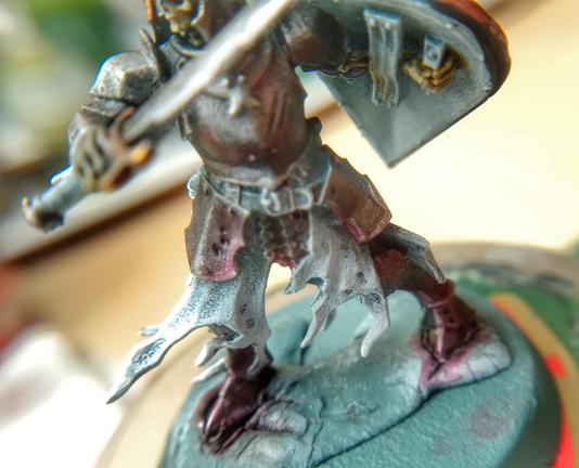 Same miniature with focus on the feet with a lot of purple lighting.