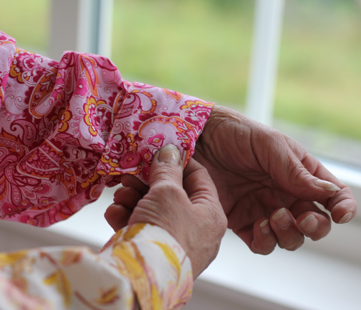 Detail of the cuffs of the shirt, one pink and one yellow