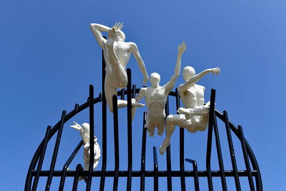 Photo of  four life-size bronze figures and steel grid. Installed on the Hove Plinth on 17 September 2023. City of Brighton & Hove, UK.