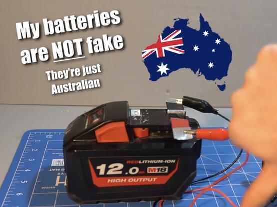 a milwaukee M18 power tool battery pack with sketchy set of leads hooked up to it on a workbench, with the text ‘My batteries are NOT fake. They're just Australian’ and a map of australia textured with the australia flag