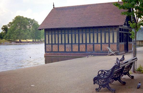 A 'half-timbered' boat shed, overlooking a lake.