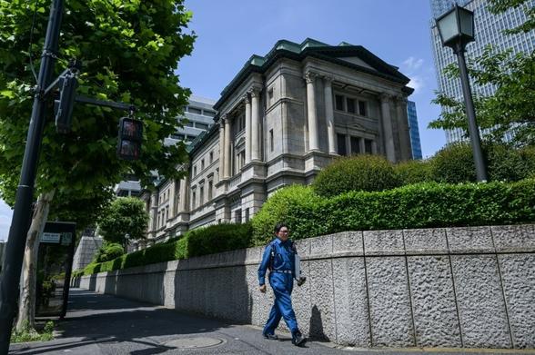 Bank of Japan holds rates, will slow bond purchase taper