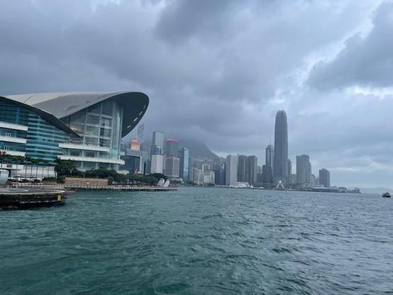 Hong Kong Convention and Exhibition Centre, Hong Kong
by the water, with skyrises in the background, and dark clouds
