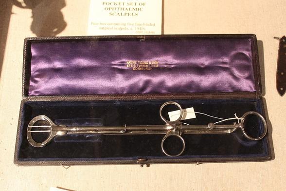 Tonsil guillotine
elongated chrome medical instrument with two finger loops in the middle. The mecanism is mysterious.
It is presented in a fancy case lined with purple satin