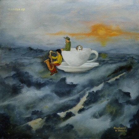 Surreal album cover for Mandée EP by Flughand & Stelich. It features two figures—one playing saxophone and another with a soccer ball—sitting on a floating teacup above a misty, dreamlike landscape with soft blue-grey hills and a golden sun on the horizon.