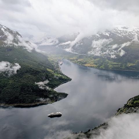 A photograph of Olden in Norway from the top of the Loen skylift. Two cruise ships are moored in the fjord.
