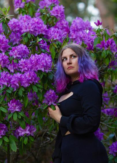 A finnish woman posing in front of Rhododendron