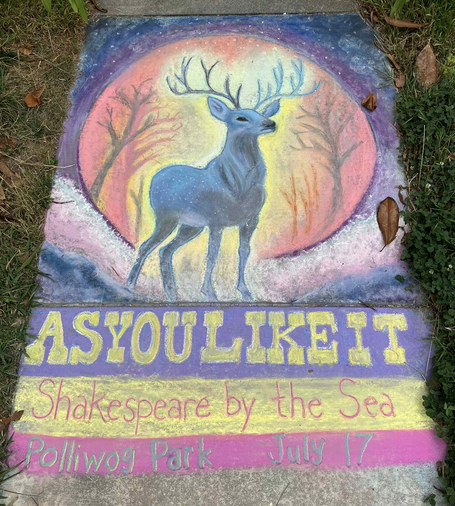 A chalk drawing on pavement, featuring a blue stag in front of a yellow and pink circle, surrounded by purples and blues; caption in chalk says "As You Like It" "Shakespeare by the Sea" "Polliwog Park July 17".