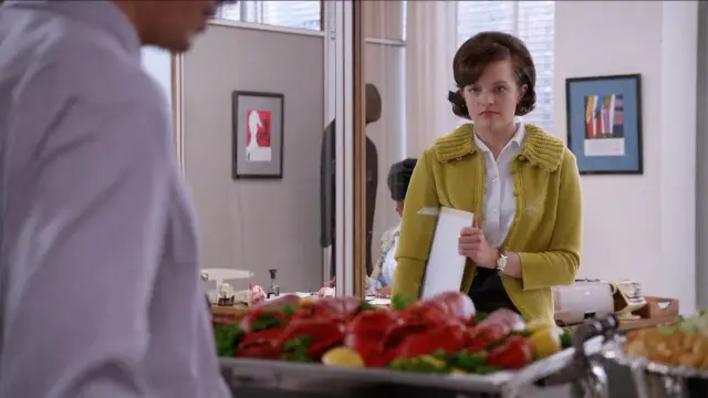 A woman looking longingly at lobsters.