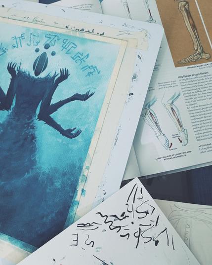 Photos of a painting workshop with a drawing in progress depicting a multi-armed fantasy creature