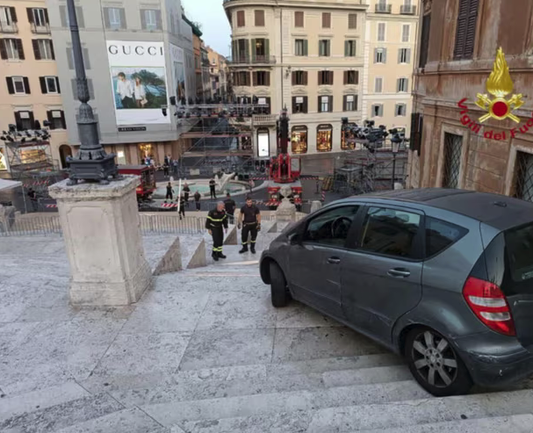 Photo the car tries to get down the steps - and gets stuck