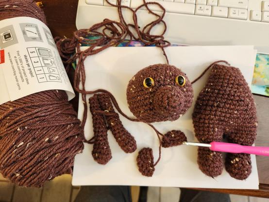 Using Brown Tweed, color yarn from Big Twist.  I made another bear using the same pattern I did the smaller  Trans colors bear in. Laid out on my desk are the pieces for the bear that need to be finished. The arms,ears, and head need to be sewed on.