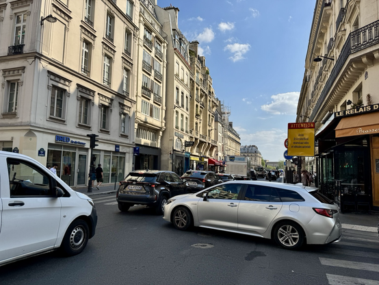 A pair of street crammed with cars