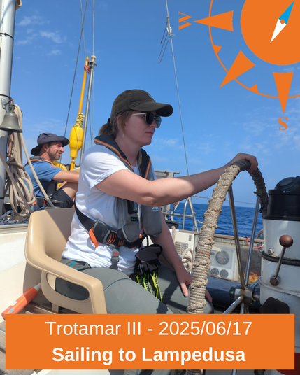 ein Crewmitglied am Steuer der Trotamar III