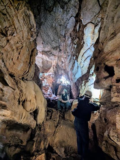 A cave, cavers in foreground