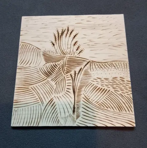 Tableau en bois d'érable pyrogravé représentant un paysage