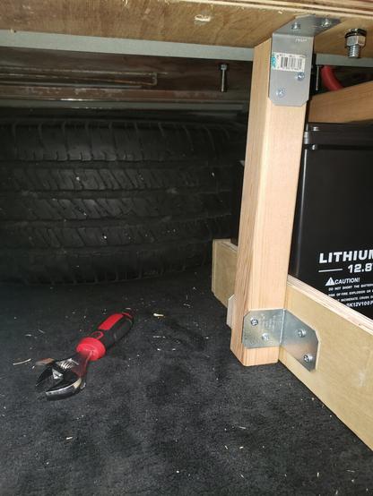 An image showing how the tire is stuck behind the wooden cage.