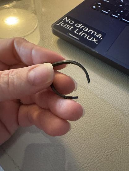 A hand holding a cut tiptie