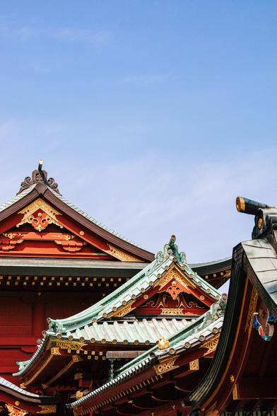 photo of the roofs of some old religious shrine on a clear, sunny day