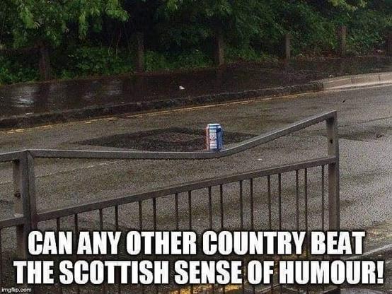 A metal fence beside a road with a hefty dent in the top rung on which has been placed a can of the famous Scots "hard strong" fizzy drink IRN-BRU
suggesting the can dented the fence
Below is white writing
CAN ANY OTHER COUNTRY BEAT THE SCOTTISH SENSE OF HUMOUR