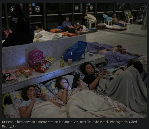 people lying in a metro station in Israel staring at their phones