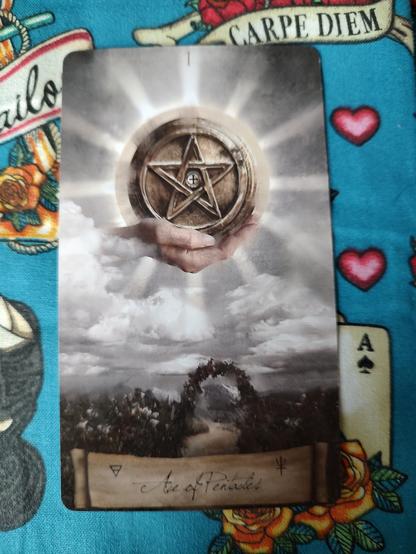 Card from the Heaven and Earth Tarot deck.
Ace of Pentacles.
A hand emerges from clouds, holding a large coin (pentacle) above a garden.