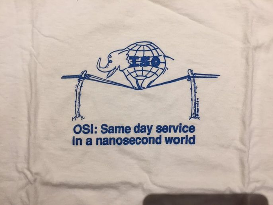 An elephant with the "ISO" globe logo for a body, standing on top of telephone wires between two bending poles.  The caption below reads: "OSI: Same day service in a nanosecond world."

This picture is no more recent than early 1991, possibly even 1990. It was drawn during the early days of the OSI vs. TCP/IP protocol standards wars.
