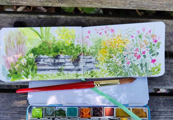 A sketch across a long, horizontal, two page sketch book of lush garden beds and a stone wall. Flowers, mostly pink, and grasses too.